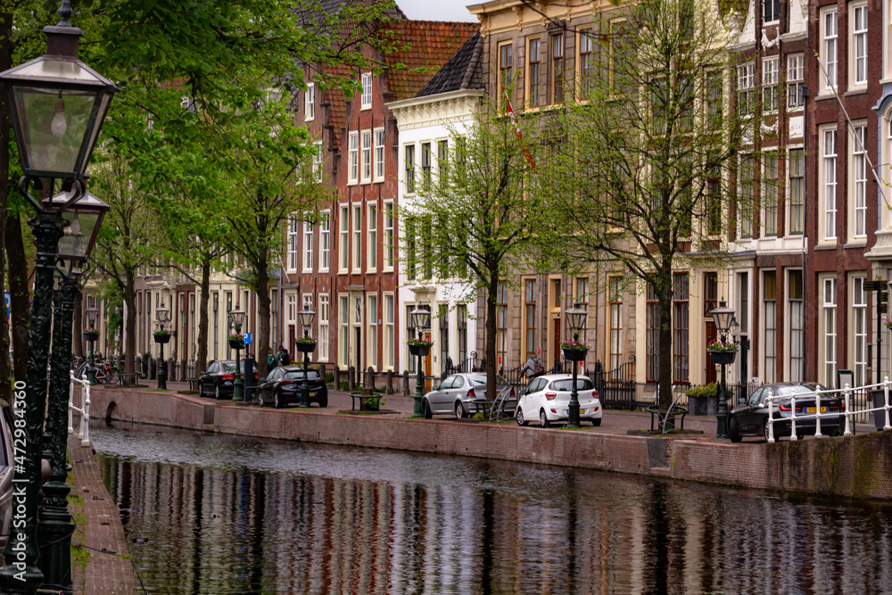 Fototapeta premium Beautiful and quaint street view with old buildings and greenery in spring in Leiden, Netherlands