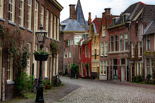 Beautiful and quaint street view with old buildings and greenery in spring in Leiden, Netherlands
