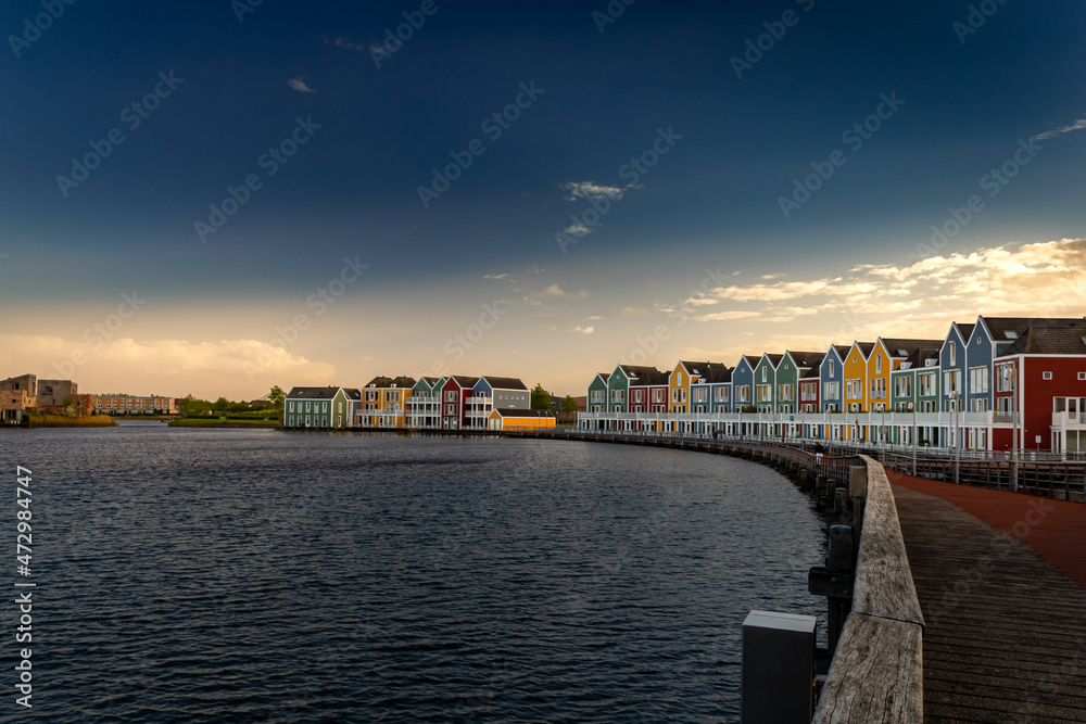 Colorful houses at sunset by the water in Houten, Netherlands