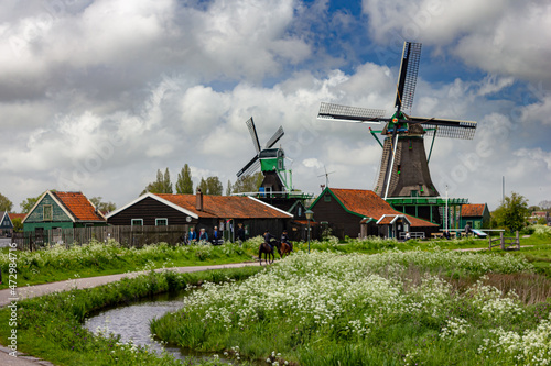 Beautiful small houses by the water with windmills in Zaanse Schans  Netherlands