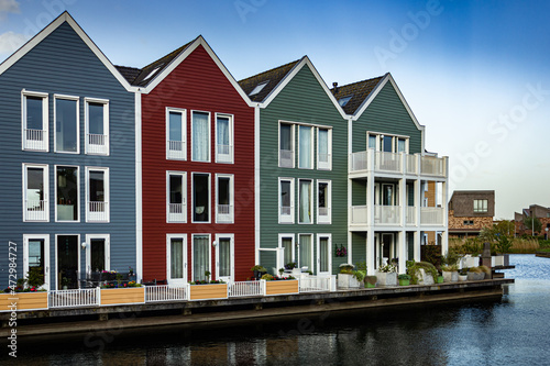 Colorful houses at sunset by the water in Houten, Netherlands