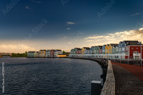 Colorful houses at sunset by the water in Houten, Netherlands © Erol