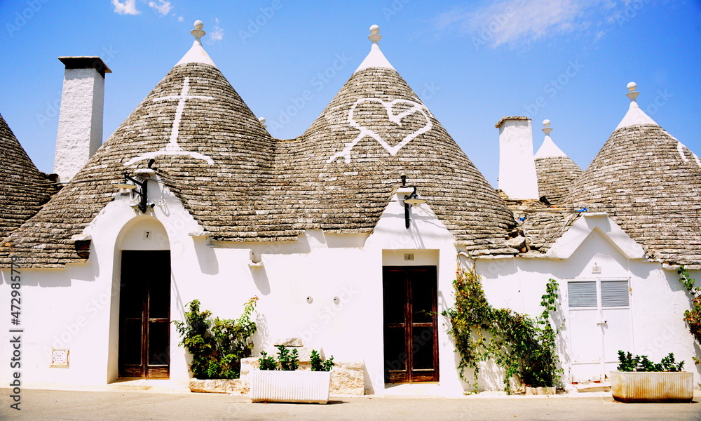 Alberobello is a city in Puglia, Italy. It is known for the Trulli, white conical stone buildings, present by the hundreds in the hilly district of Rione Monti.