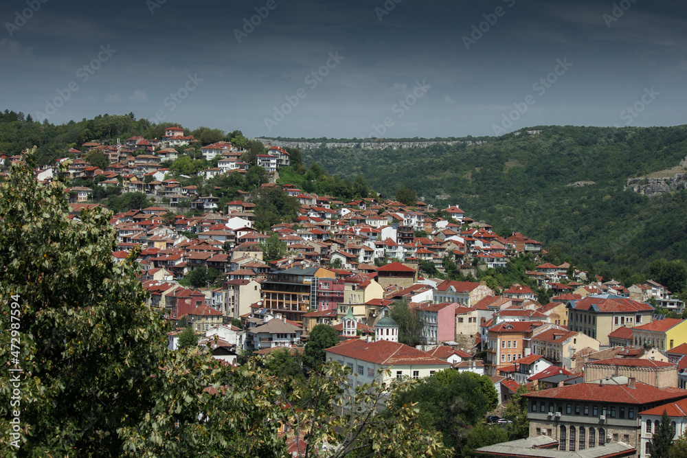 Fototapeta premium City in mountain area with greenery in summer day in Veliko Tarnovo, Bulgaria
