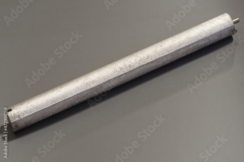 New Magnesium anode on grey background. Selective soft focus. photo