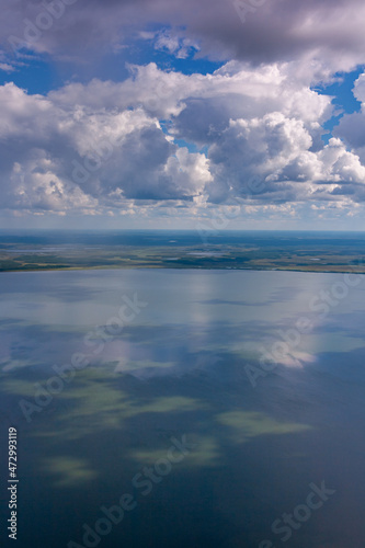 Air photo of lake during cloudy summer day