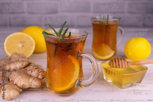 Ginger tea with lemon and honey in small glass cups.