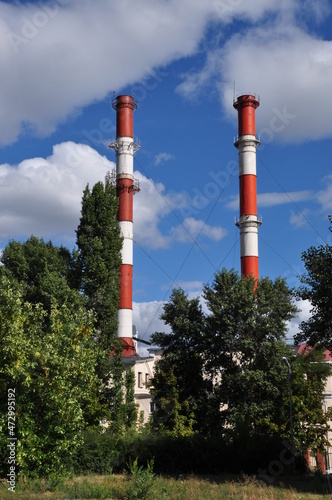 Two large pipes of a thermal power plant. City panorama. High pipes of the CHP.