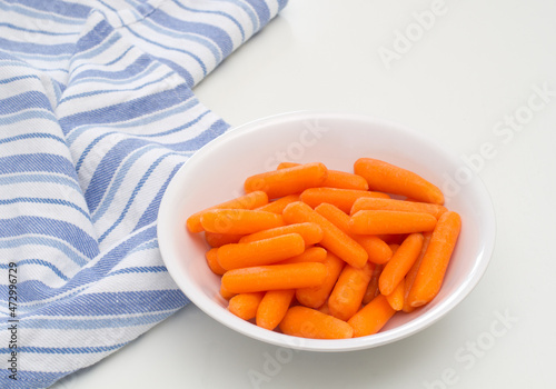 Baby cut carrots in bowl on kitchen tabletop