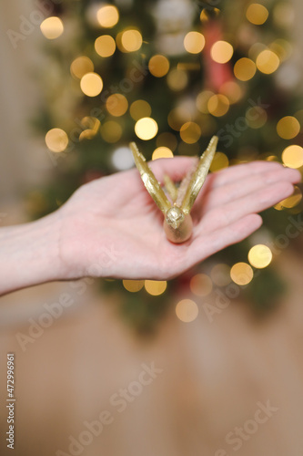 hand holding toy and decorating Christmas tree. Holiday, Christmas and New Year celebration concept © paralisart