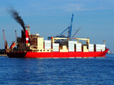 Exhaust smoke emissions from container vessel docking at port facilities.