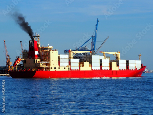 Exhaust smoke emissions from container vessel docking at port facilities.