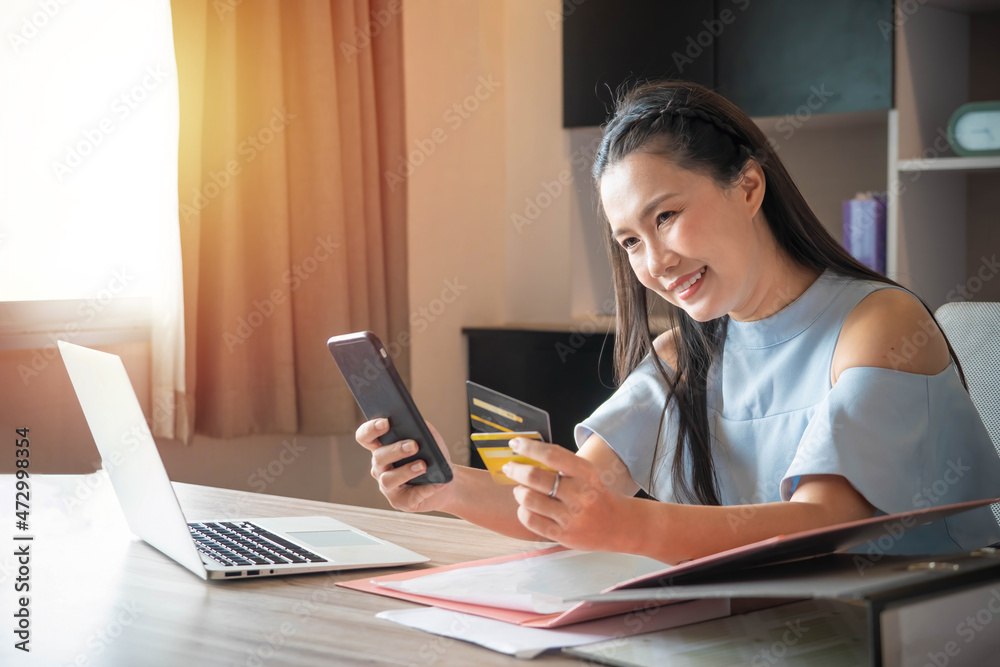 Fototapeta premium Business woman using mobile phone and credit card or shopping online .