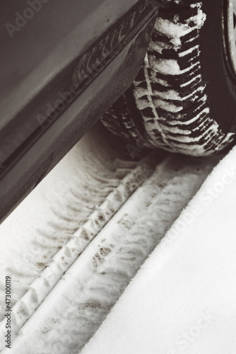 Car tyre track in snow photo