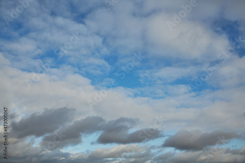 The blue sky is visible through a veil of gray clouds Atmosphere