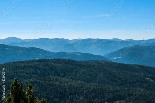 Bergige Landschaft in Österreich. Blick von einem hochgelegenen Punkt auf eine Gebirgskette. Sonniger Herbsttag