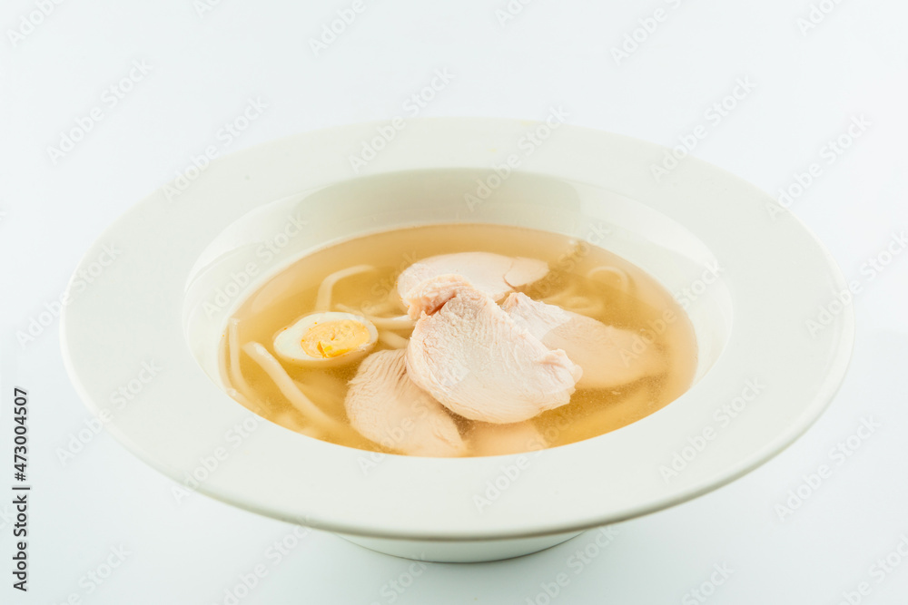 Classic Chicken broth with quail eggs and wheat noodles. Chicken soup stock served in white plate. First dish consomme isolated on white background
Classic Chicken broth with quail eggs and wheat noodles. Chicken soup stock served in white plate. First dish consomme isolated on white background