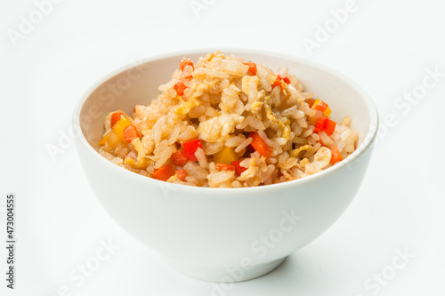 Asian vegetable rice bell pepper, onion, carrot and scrambled egg served in white bowl. Spicy Thai Dish isolated on white background. Copy space image 
