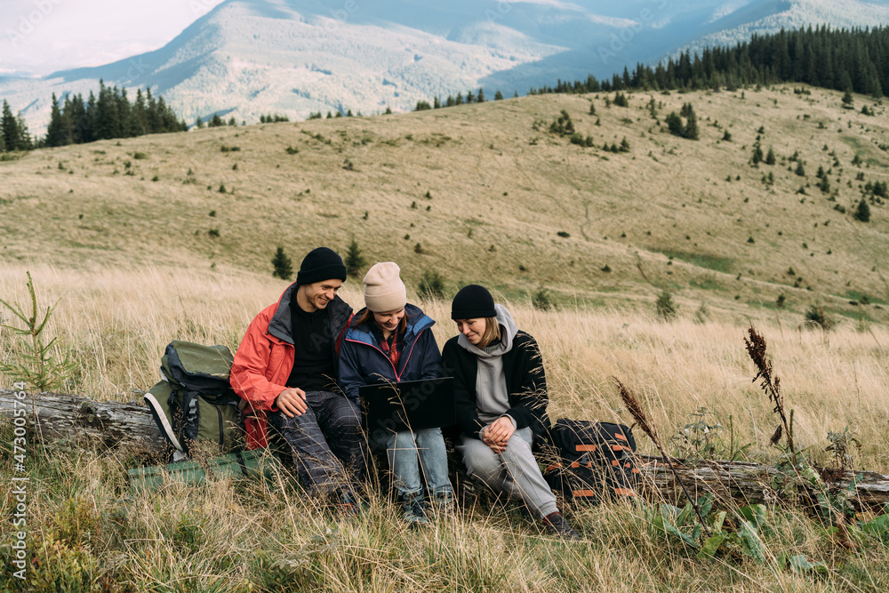 Group of happy Caucasian male and female tourist friends enjoy hiking and together on the mountain in autumn. Group of happy Caucasian male and female tourist friends enjoy hiking and together on the mountain in autumn.