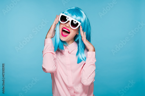 attractive woman in purple wig sunglasses model blue background