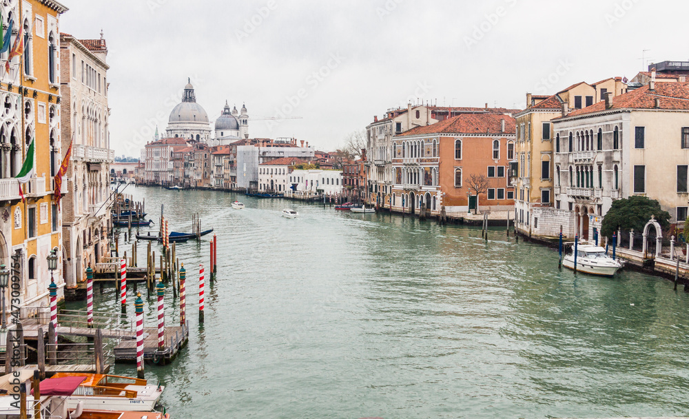 Canals of Venice with its typical gondolas , palaces and italian architecture
