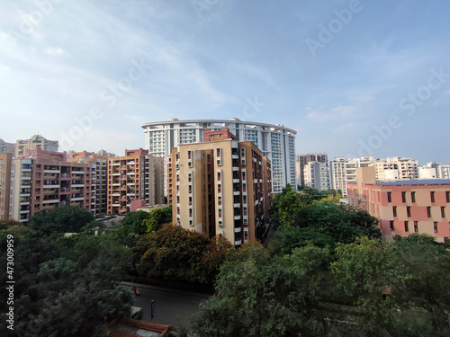 Office and residential buildings in the evening at Pune India, Cityscape with modern apartment buildings in a new residential area in the Pune city, trees around the building.