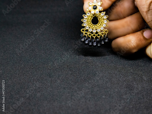 Jewellery for women. Earrings for girls. A earning holding in a hand.