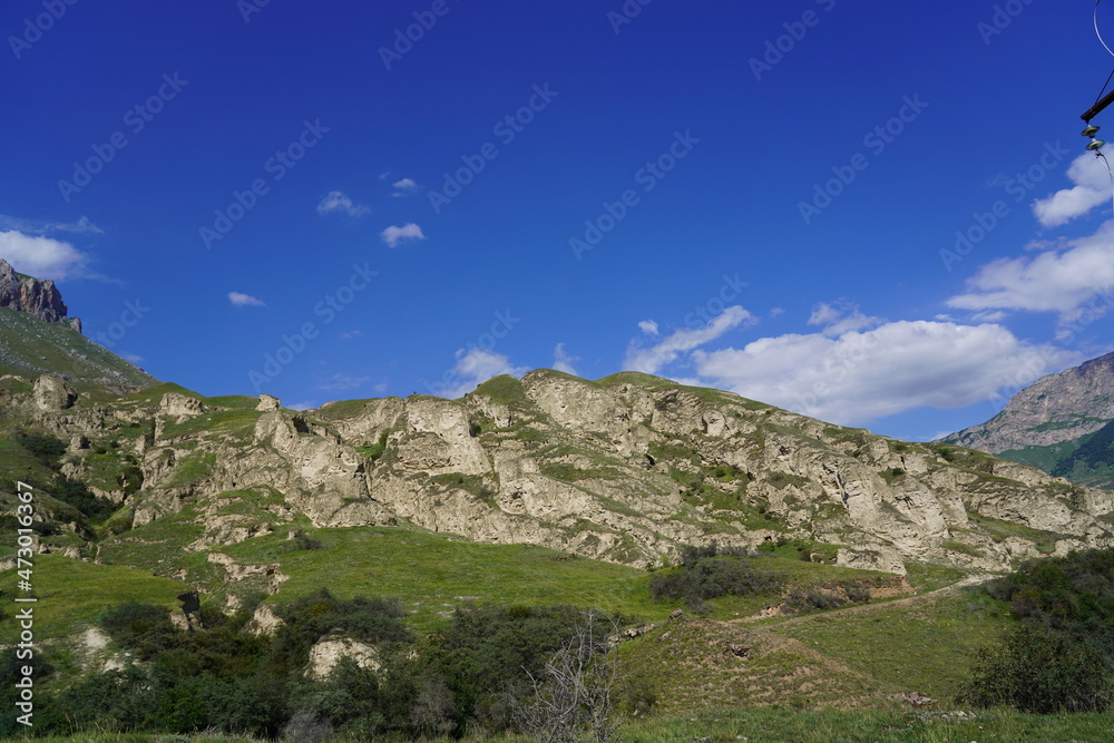 Landscape with sky and clouds. Rocks and hills