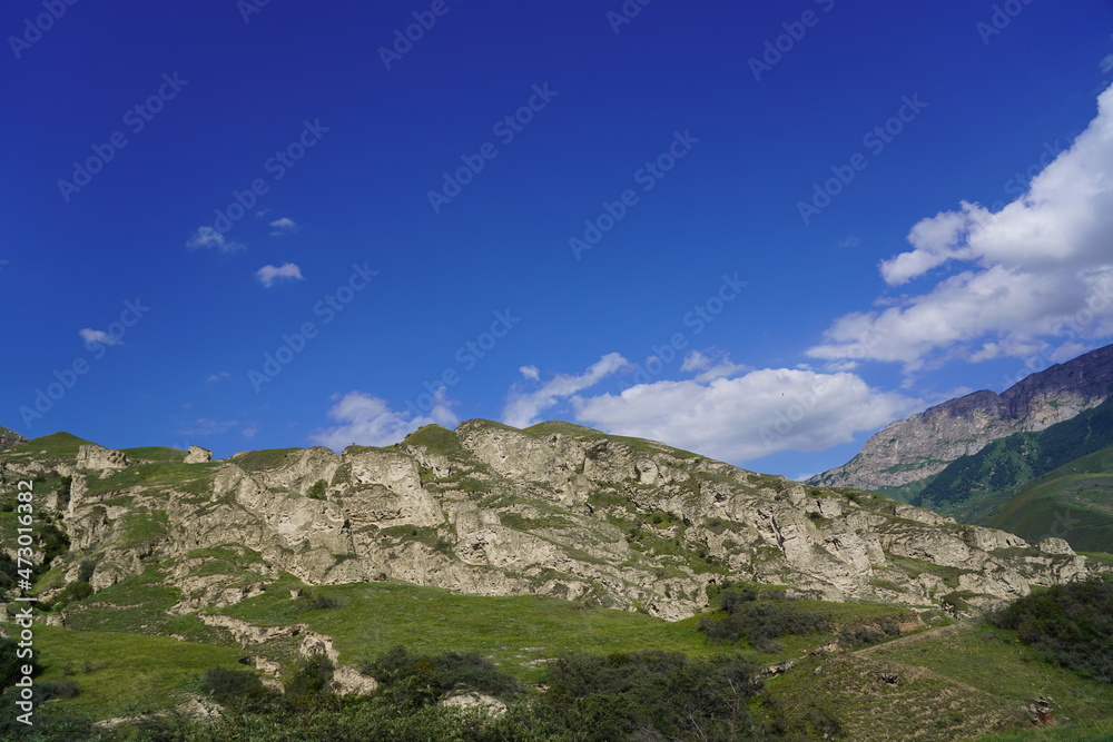 Landscape with sky and clouds. Rocks and hills