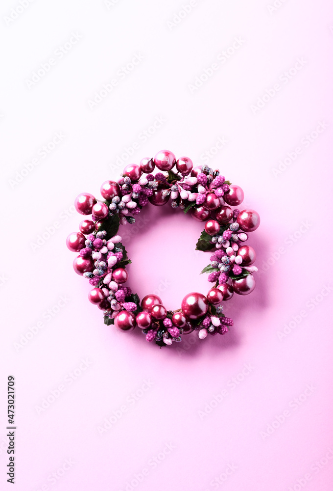 Christmas Wreath on bright paper background. Top view. Copy space.
