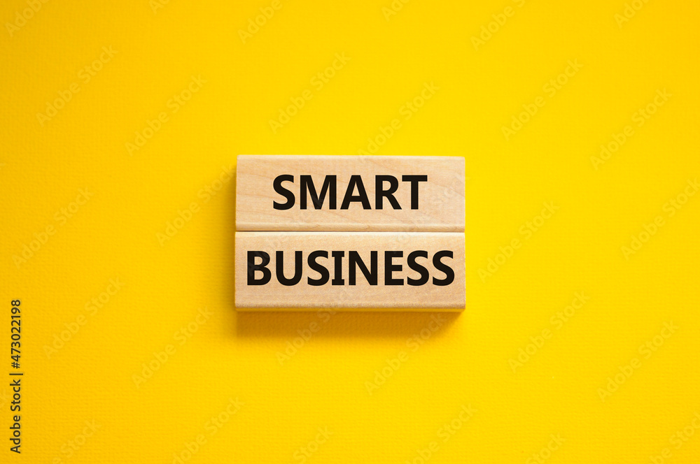 Time to smart business symbol. Wooden blocks with words 'Smart business'. Beautiful yellow background. Smart success business concept. Copy space. Time to smart business symbol. Wooden blocks with words 'Smart business'. Beautiful yellow background. Smart success business concept. Copy space.