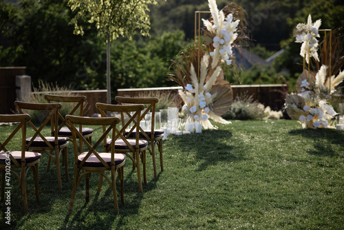 Natural wood chairs on a field with green grass