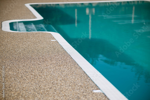 Clear clear water in the swimming pool. Stairs to the pool and side