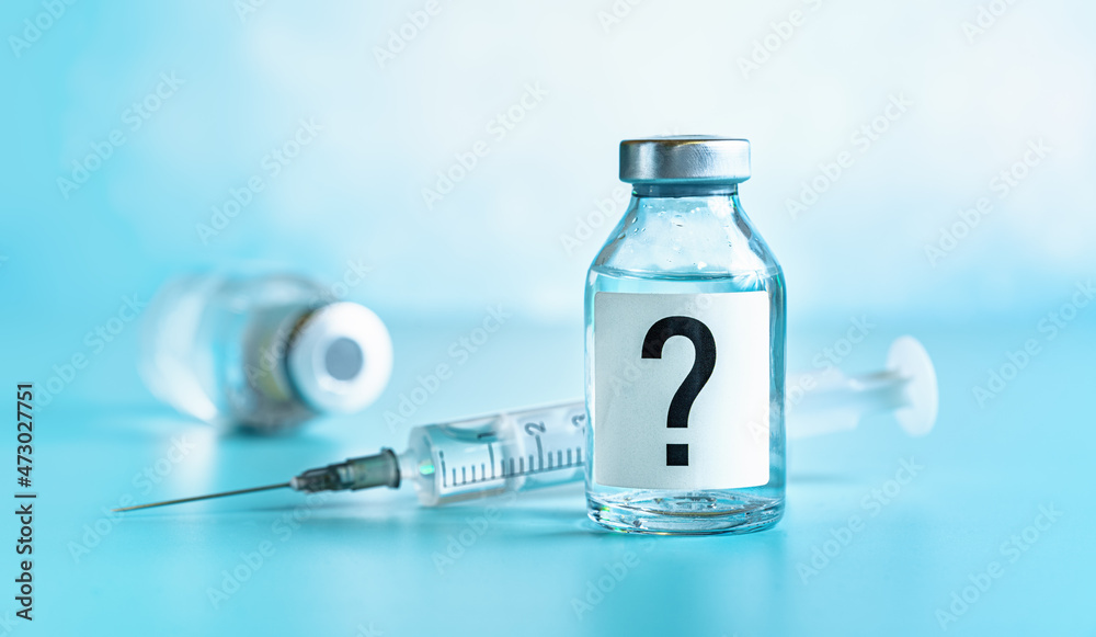 Vaccine bottle with hypodermic syringe needle near, question mark on label, another blurred vial blue background Vaccine bottle with hypodermic syringe needle near, question mark on label, another blurred vial blue background