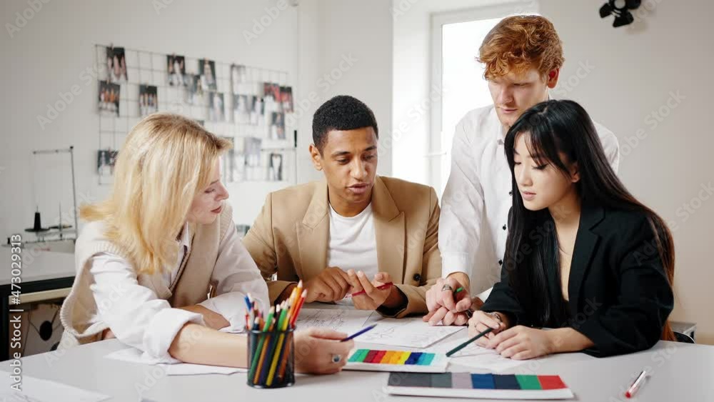 Creating new brand book. Multiethnic young business team discussing new project for client, choosing colors and design