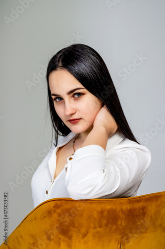 Beautiful, young girl with long black hair, in a white shirt, portrait. photo