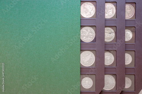 Numismatic album with antique coins collection. Green numismatic case with copy space photo