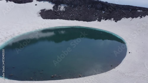 The blue lake in the crater of Gorely volcano. Kamchatka Peninsula, Russia