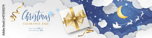 Vector Christmas sale banner with 3d gift box, gold ribbons and bow, paper cutout of winter scene with clouds, Santa's sleigh flying around the moon. Festive layered background for header of website.