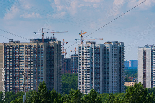New buildings in the south-west of Moscow. Various stages of construction. Cranes in an urban environment