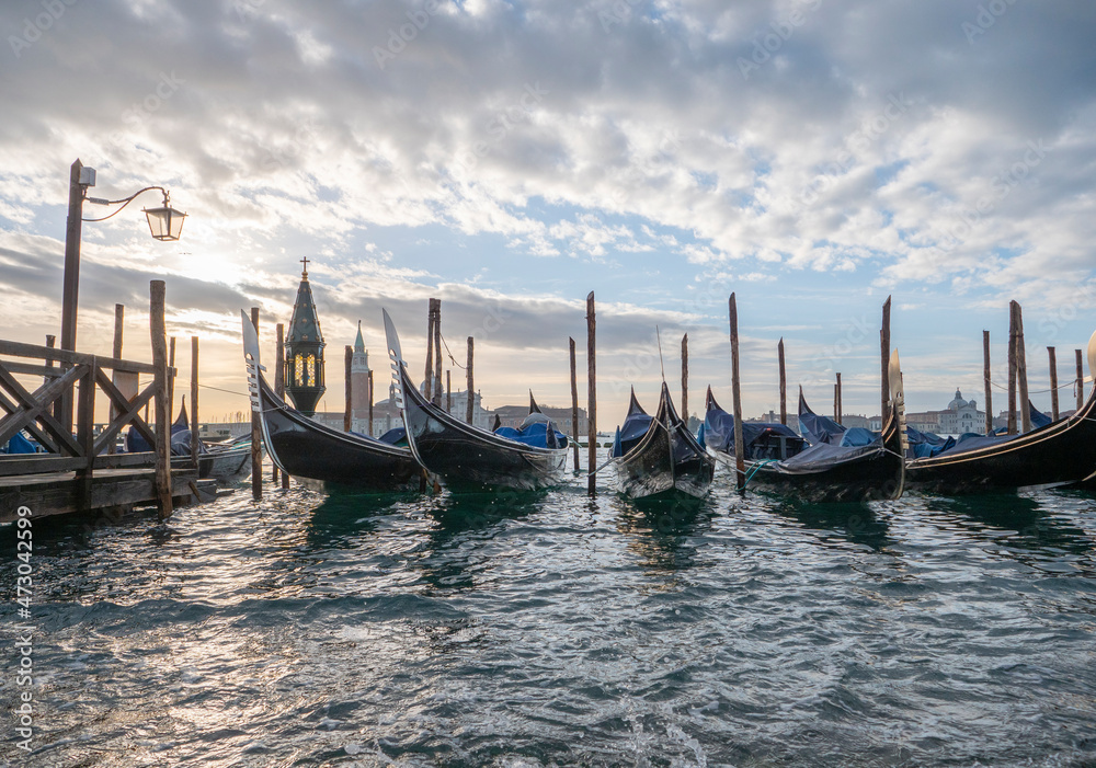 gondola boats in St. Mark's Square, long boats on the water moored in Venice