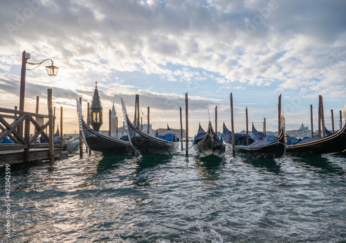 gondola boats in St. Mark's Square, long boats on the water moored in Venice