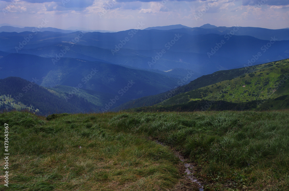 Naklejka premium Mountain panoramic landscape with clouds and blue sky