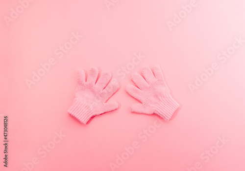 Soft pink glowes on a pink background. Winter minimal flat lay concept.
