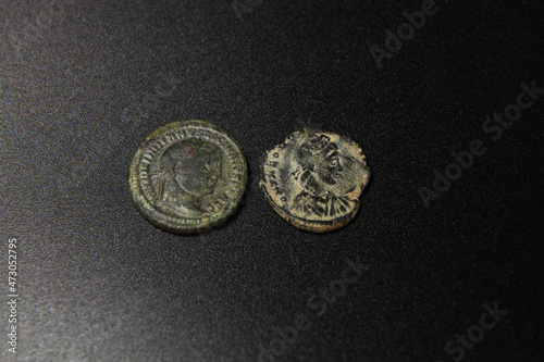 Two coins on ancient Rome on black background