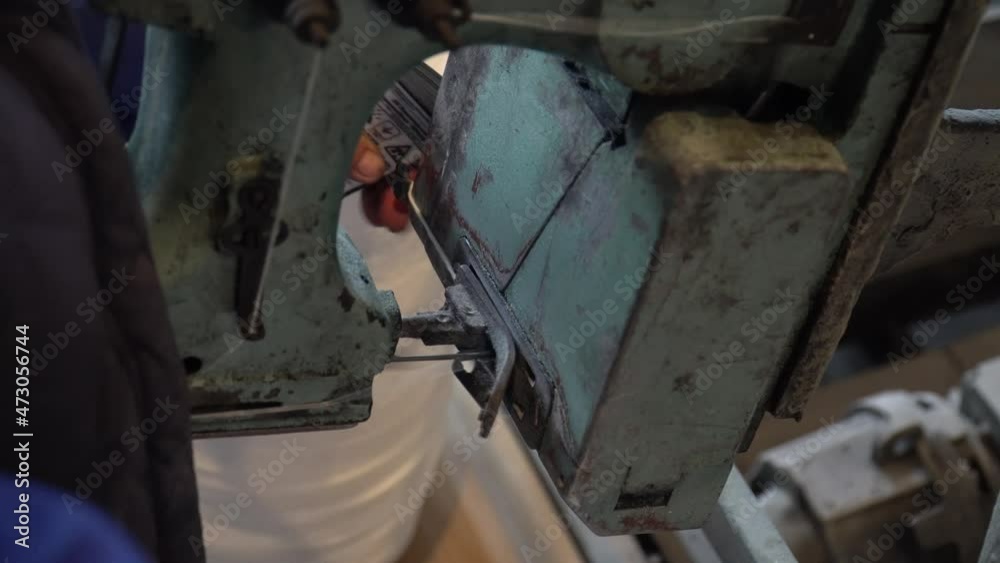 A female worker packs sugar using machine on the conveyor belt of sugar beet plant. Scoop in burlap sack, sackcloth bag. Transparent plastic bag. Stacked grocery. Close up A female worker packs sugar using machine on the conveyor belt of sugar beet plant. Scoop in burlap sack, sackcloth bag. Transparent plastic bag. Stacked grocery. Close up