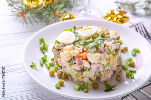 Traditional Russian salad Olivier for Christmas and New Year on a white background. Close up view