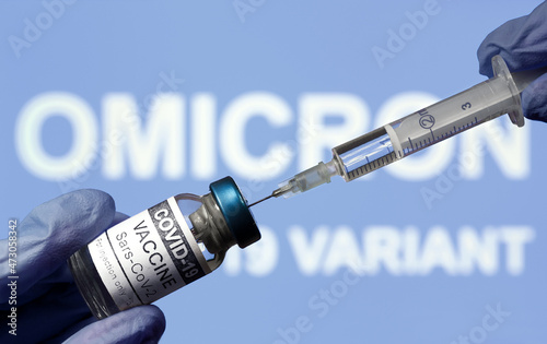 Omicron COVID-19 variant and coronavirus vaccine, focus on bottle and syringe photo