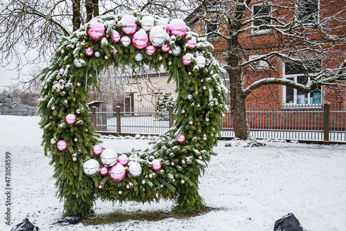 A large snow-covered Advent wreath of spruce branches and balls photo