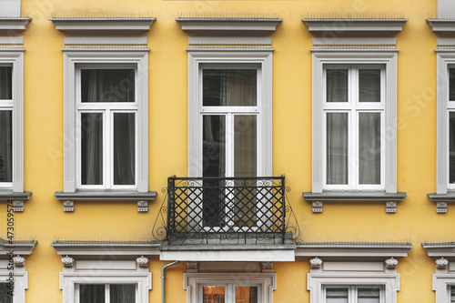 Balcony and facade of a yellow house for the background. Close-up